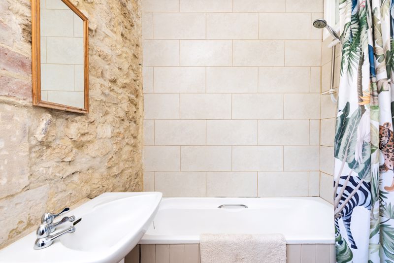 Bathroom With Exposed Stone Wall